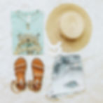 Thumbnail: Light blue colored shirt with yellow sunflowers and butterflies and writing "Normalize Sobriety" folded next to sandals, straw hat, and jean shorts.