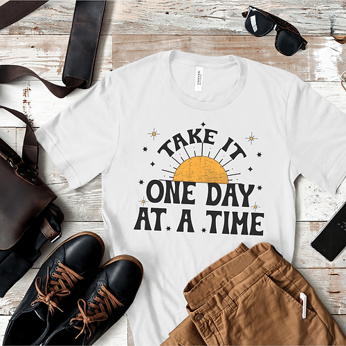 White T-shirt with sun art and text "Take it One Day at a Time"