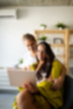 a man embracing a woman holding her tablet smiling