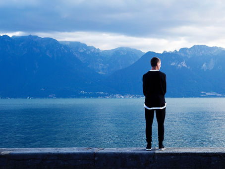 Young man looking over water