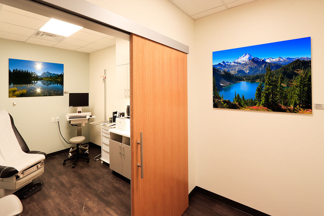 Multiple landscape photographs by Peter displayed in medical office interiors