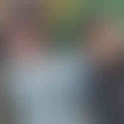 Fran grinning next to a Messi statue in El Caminito