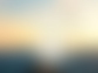 A doorway over mountains with a sunset and butterflies being released