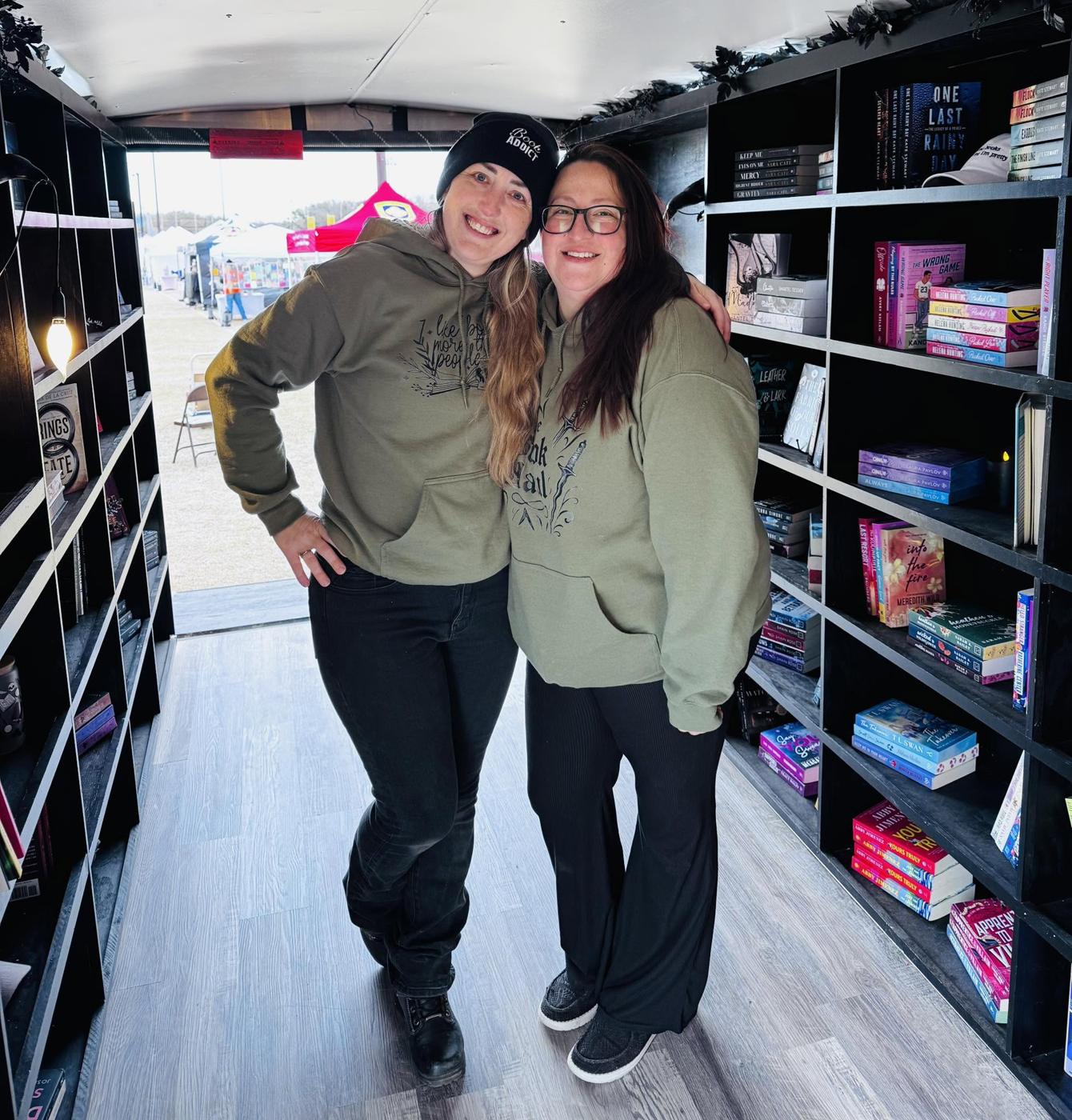The Book Haul team inside the trailer between the bookshelves