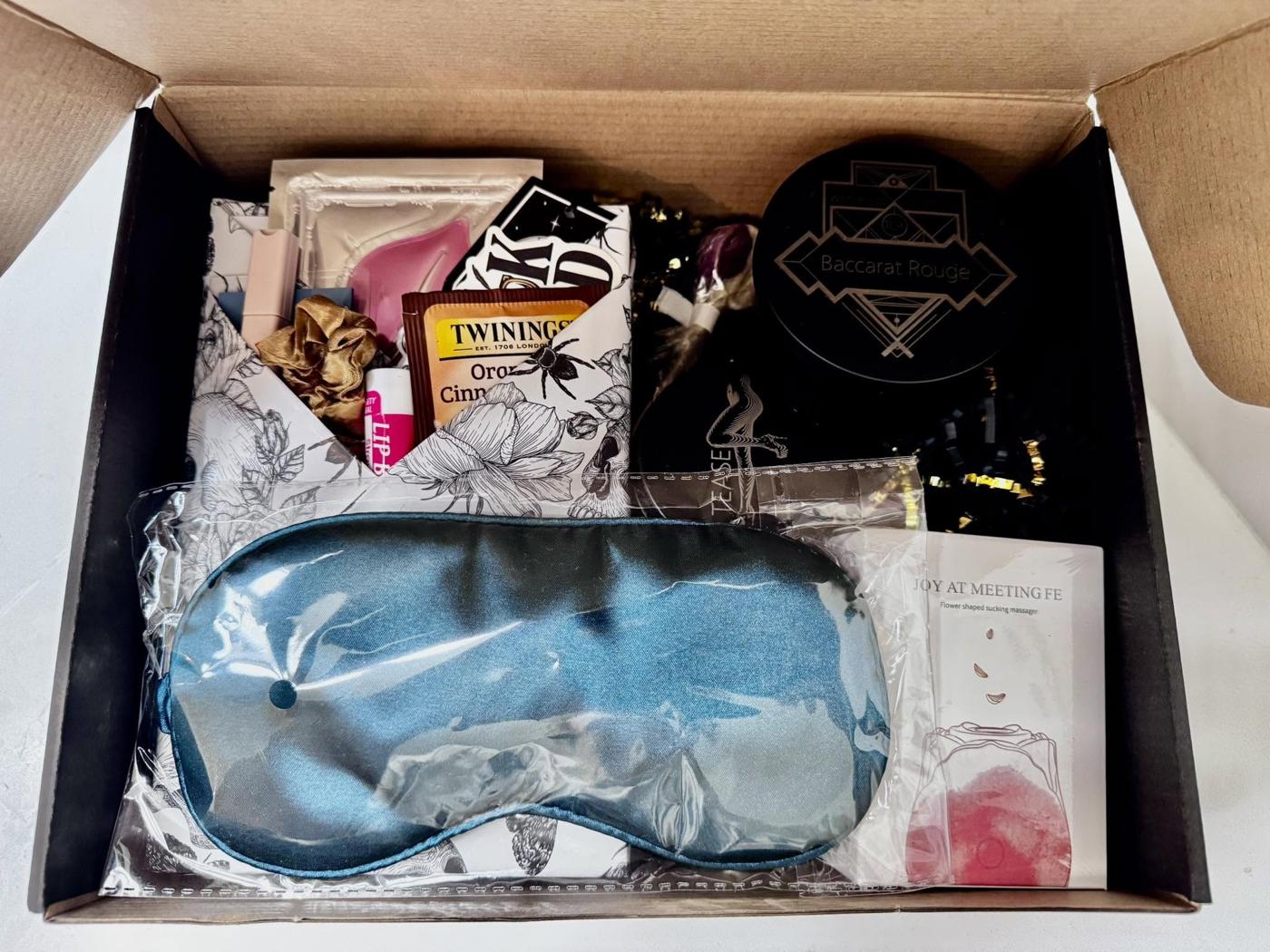 An After Dark mystery box opened to show a book and bookish goodies