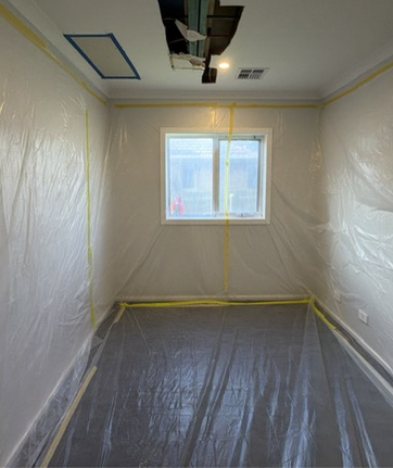 Room covered in protective plastic for renovation