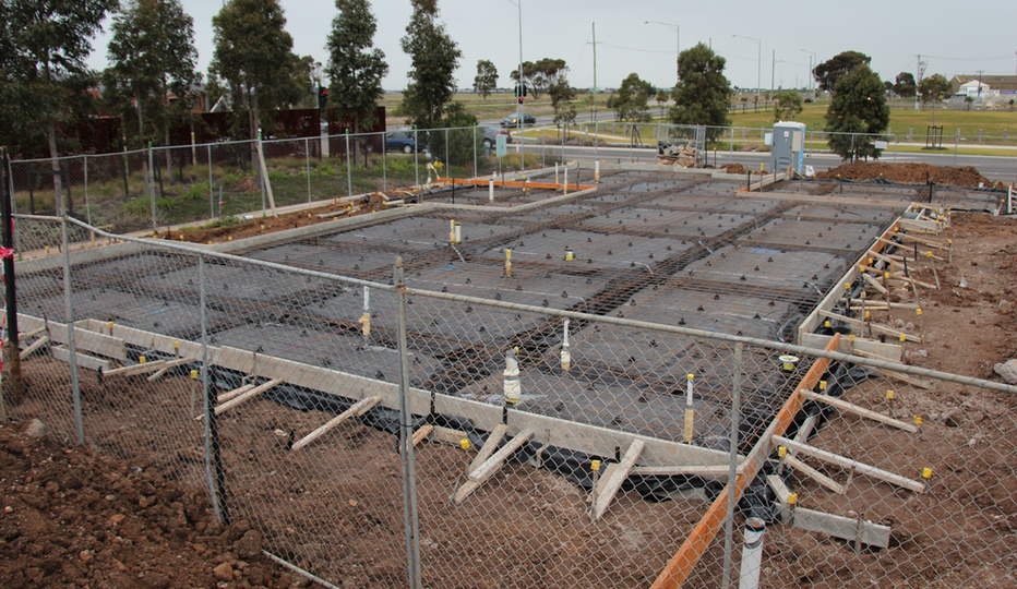 Concrete slab foundation preparation at a construction site.