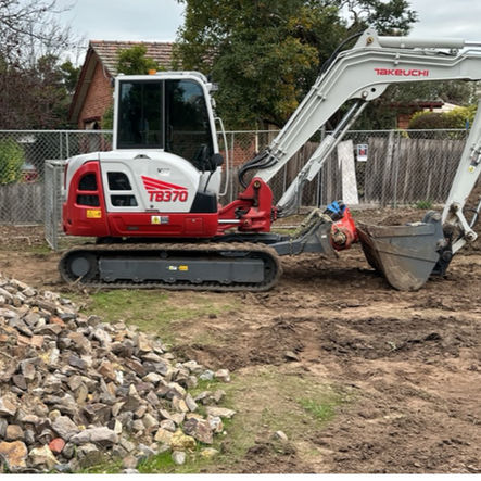 Small excavator on a construction site with rocks