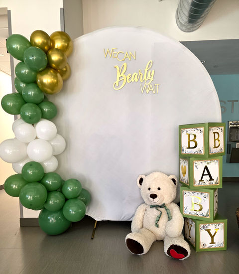 Baby shower event decor backdrop with blocks and teddy bear.