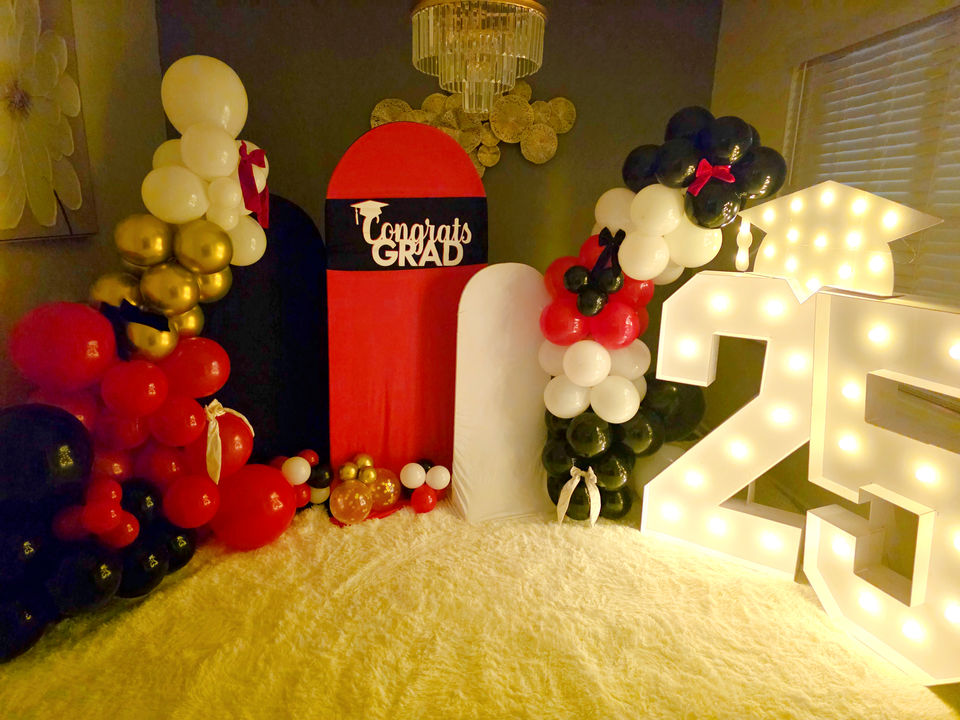 Graduation event decor with a graduating year lit up for a backdrop.