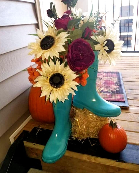 custom fall floral arrangement with sunflowers, pumpkins, and blue rain boots.