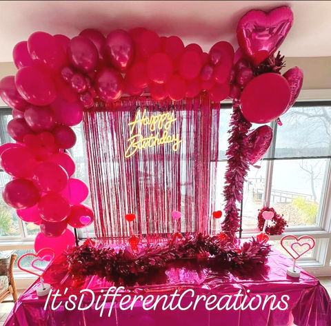 Happy Birthday special event decor with red balloons and tablescape.