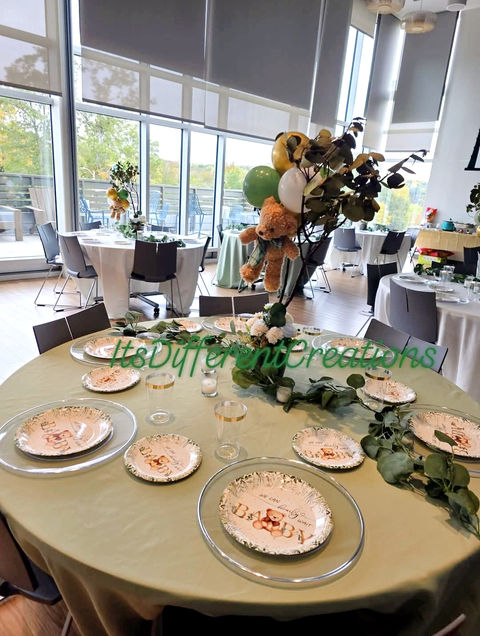 Green and gold table setting for a baby shower event in Gastonia.