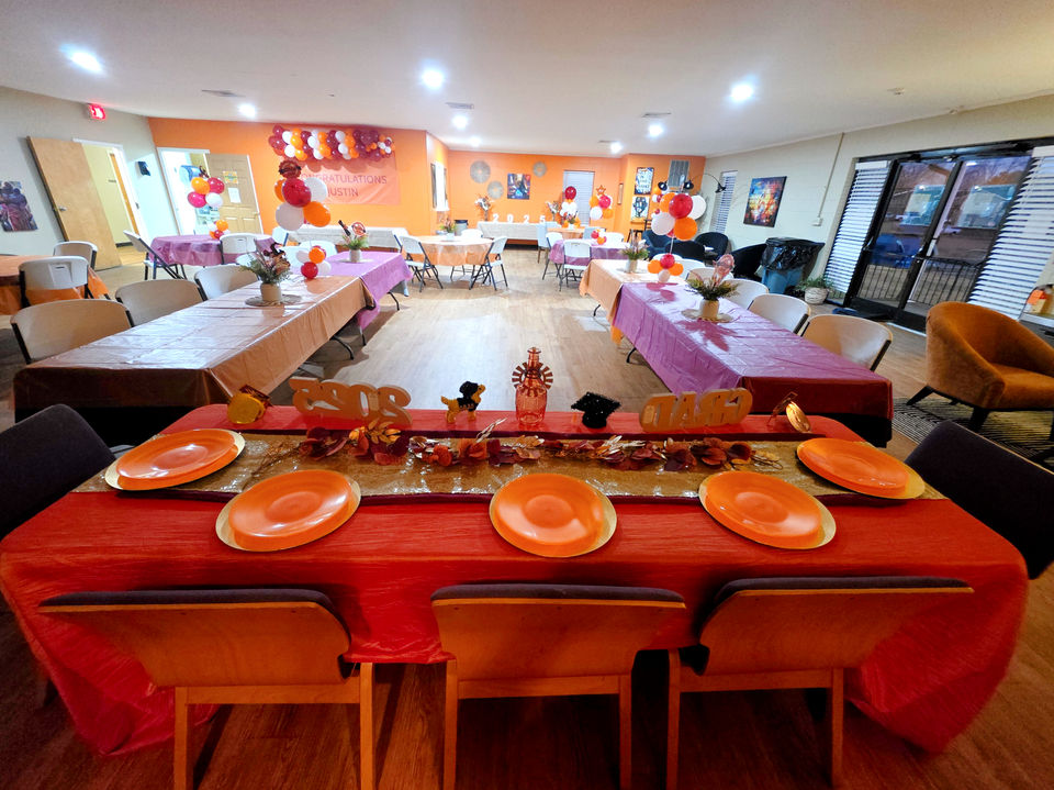 Graduation event decorator covered all of the tables in orange cloths for this special event.