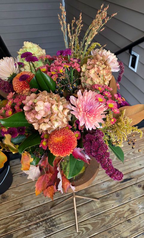 Fall floral arrangement with pink and orange dried flowers.