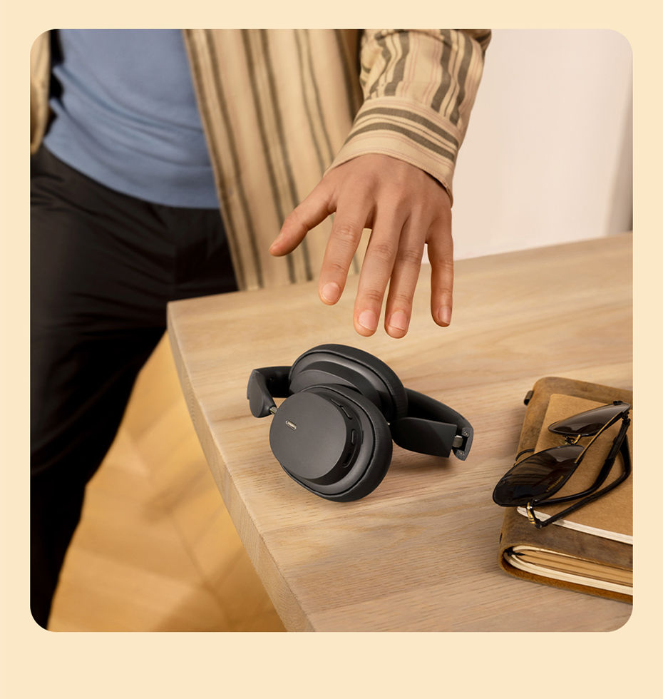 Thumbnail: Person reaching for Sony noise-canceling headphones on a desk.