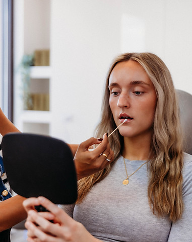 Woman getting a holistic lip assessment at TRUE Aesthetic Clinic