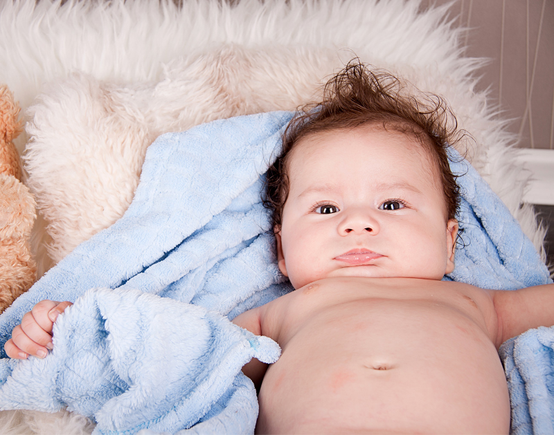 Little baby lying on a blue blanket