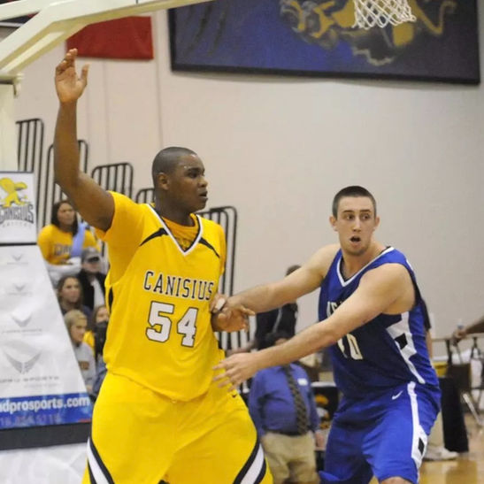 Basketball athletes competing in a game on court.