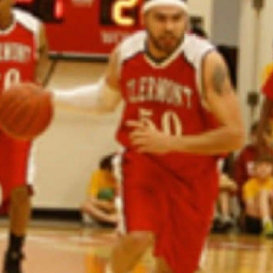 Basketball player in red Clermont jersey dribbling on court
