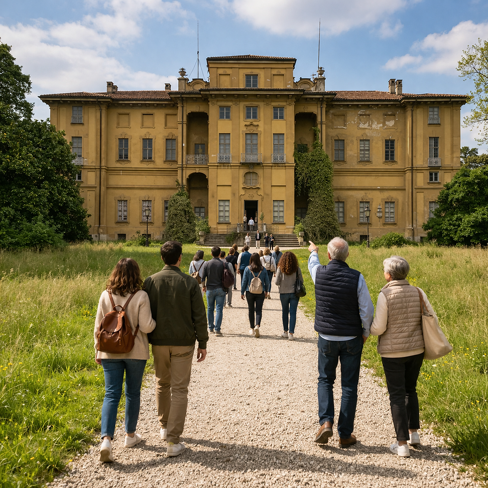 People walking toward a large, historic yellow building under a blue sky. Lush greenery surrounds the path, creating a serene atmosphere. The building name is Villa Alari
