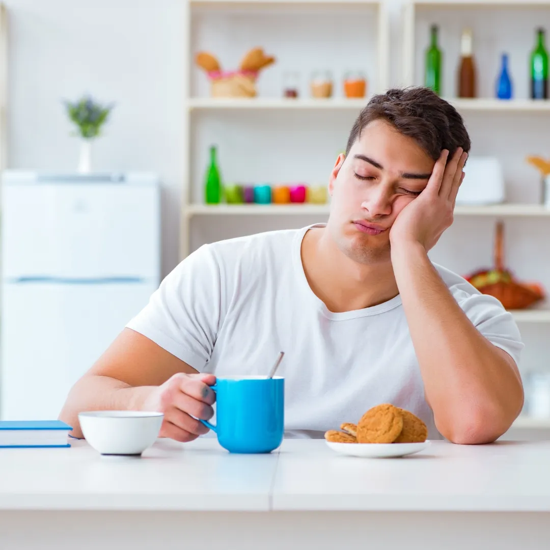 sleepy guy having coffee to wake up