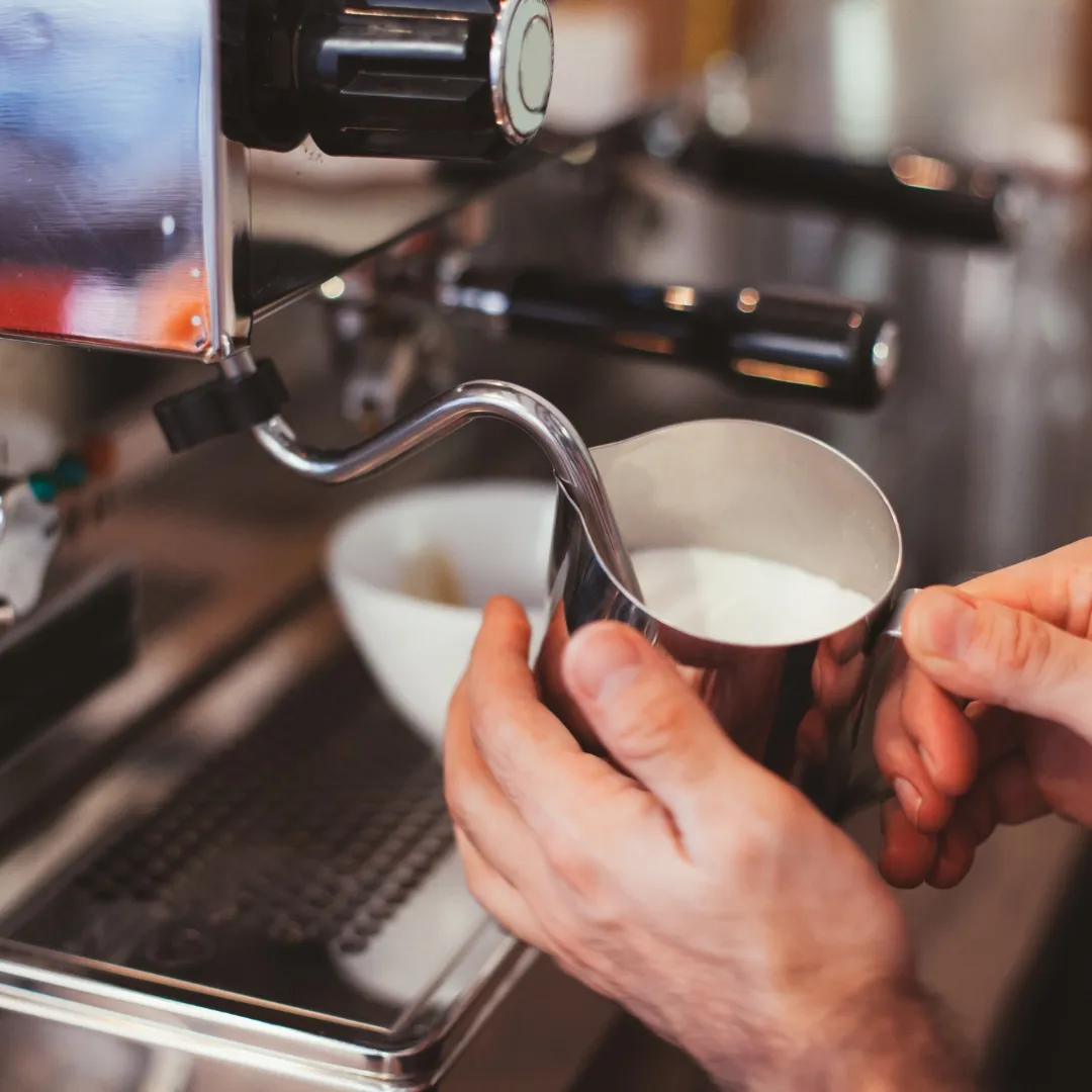 preparing the milk for a cappuccino italian style