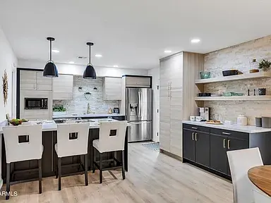 Scottsdale renovated kitchen with luxury vinyl plank flooring, custom cabinetry, upgraded lighting, and modern fixtures.