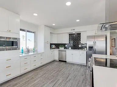 Modern kitchen in Glendale featuring upgraded appliances, custom cabinetry, electrical updates, and new flooring.