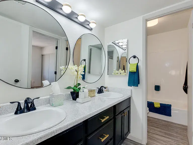 Glendale modern bathroom remodel featuring custom vanity, tile shower, updated fixtures, and luxury vinyl plank flooring.