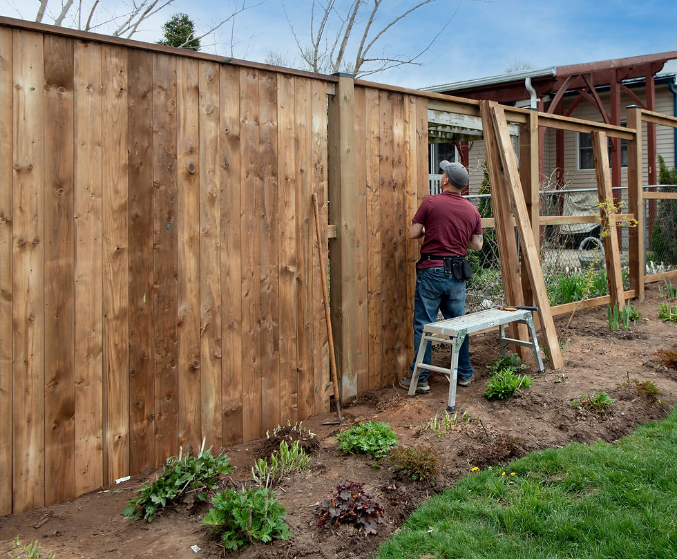 Man building a new fence in Oshawa