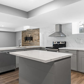 Luxury basement bar with quartz countertops, pendant lighting, and custom cabinetry.