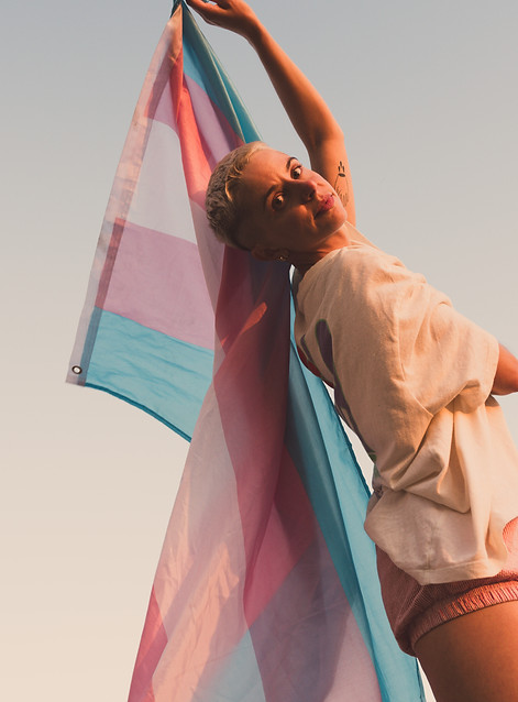 Joanna holding a transgender flag