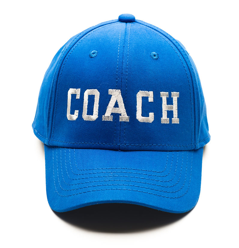 Blue baseball cap with Coach written on it