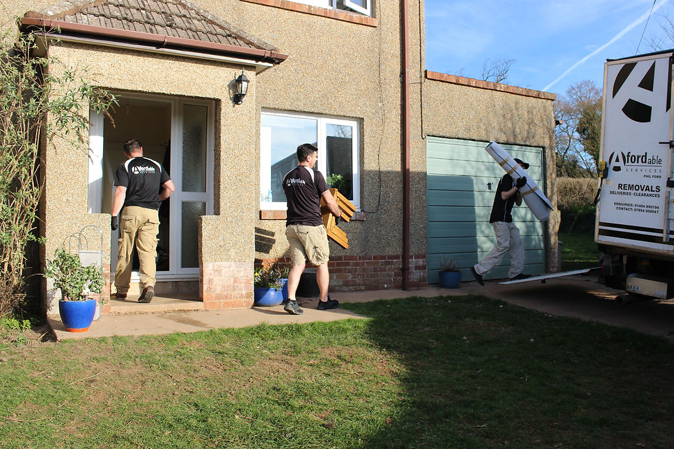 Three men and two vans loading a full house move from Devon to Worcestershire