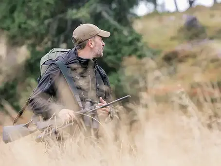 Ein Jäger auf der Pirsch, mit geschultertem Gewehr