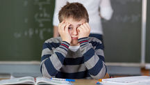 Boy Struggling in Classroom