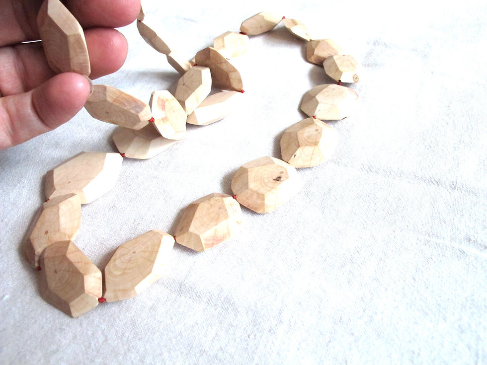 Thumbnail: Hand carved faceted wood bead necklace on red silk