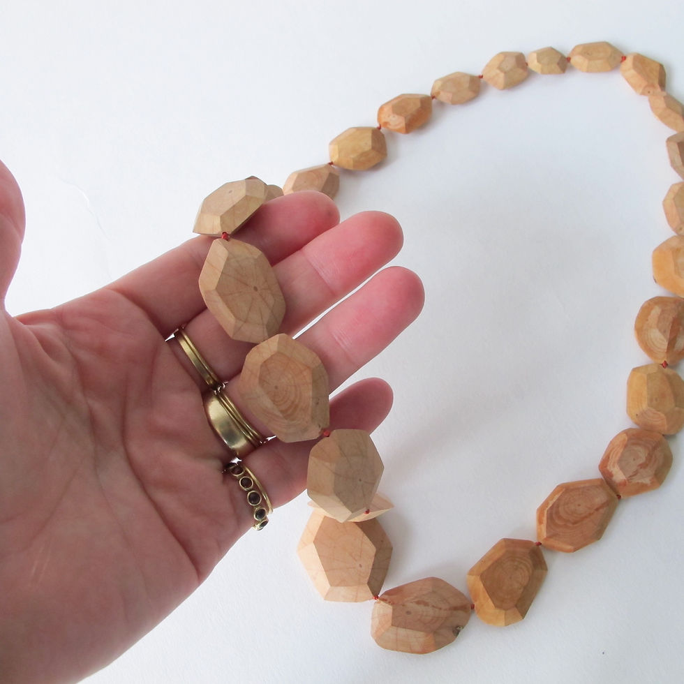 Thumbnail: Hand carved faceted wood bead necklace on red silk