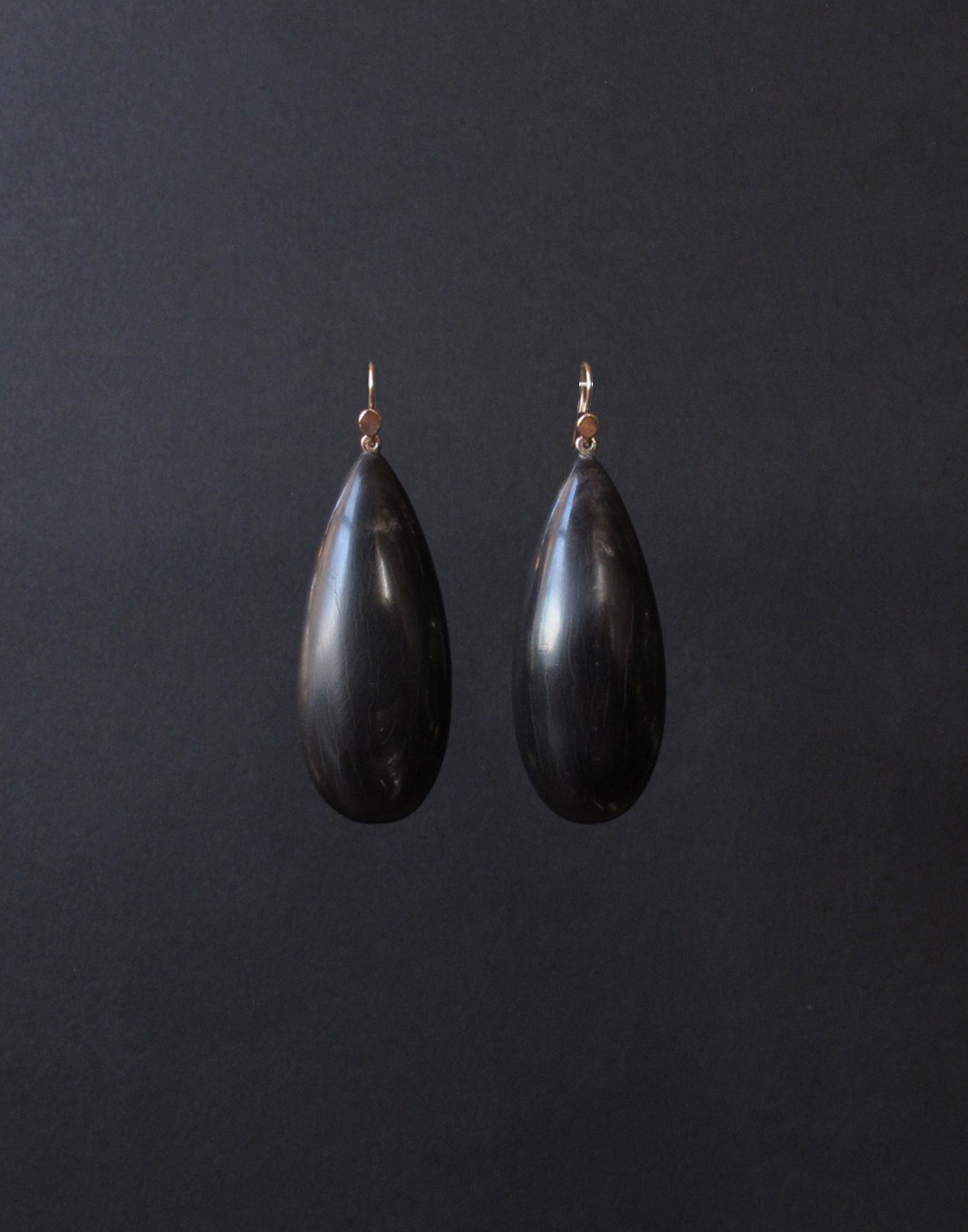 Black horn drops with white veining