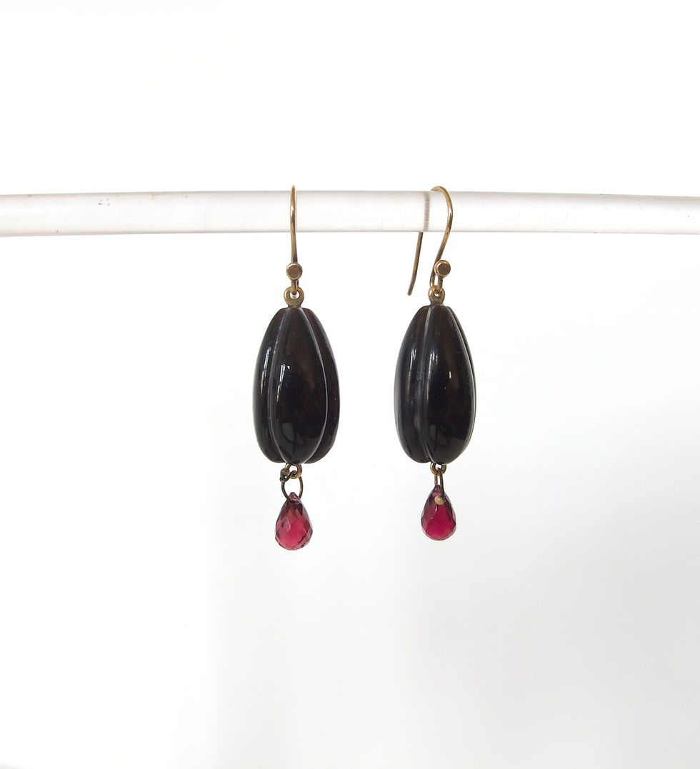 Carved horn with garnet and 14k gold