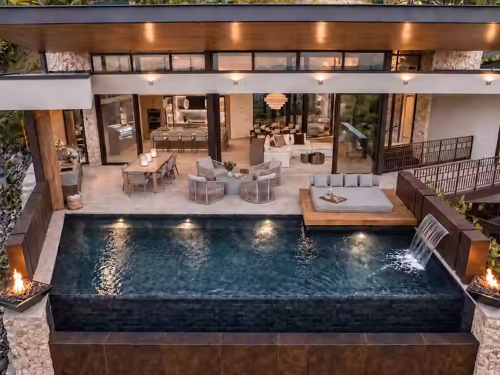 Infinity pool with waterfall feature and open-air lounge at a Costa Rica retreat villa