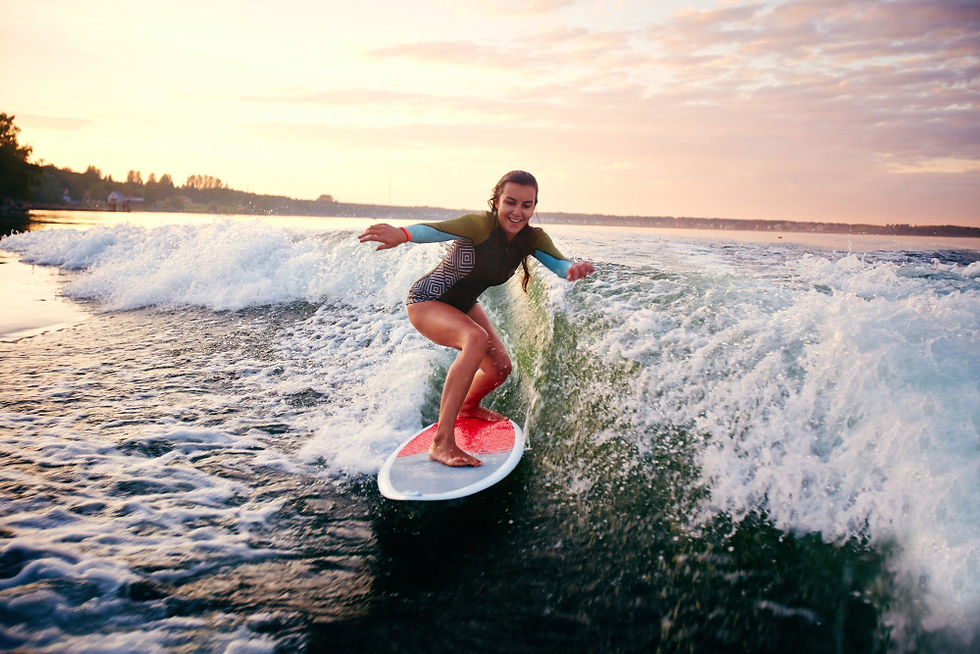 Women resting in savasana on coastal rocks at a Costa Rica retreat
Woman surfing a wave at sunset on a Costa Rica retreat surf excursion