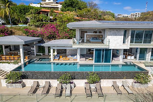 Modern exterior with infinity pool and open-air living spaces at Compass House, a luxury villa for a retreat in Costa Rica