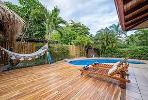 Teak deck and private pool in a tropical garden at Villa Bandera Roja, a private villa for a retreat in Costa Rica