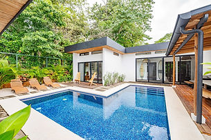 Private pool and modern white exterior at Howler Hideaway, a private villa for a retreat in Costa Rica
