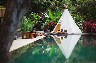 Infinity pool surrounded by tropical gardens at El Chante, a private villa estate for a retreat in Costa Rica