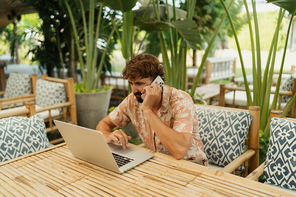 Working on a laptop at an outdoor villa table during a corporate retreat in Costa Rica