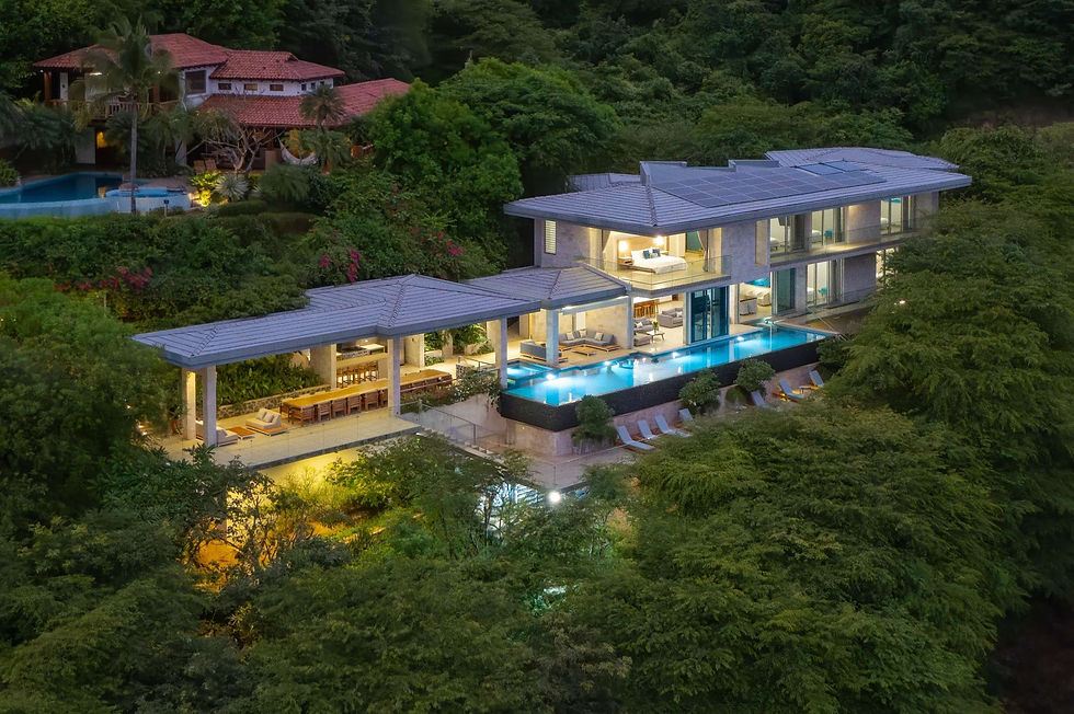 Aerial night view of a private villa with infinity pool surrounded by jungle at a Costa Rica retreat