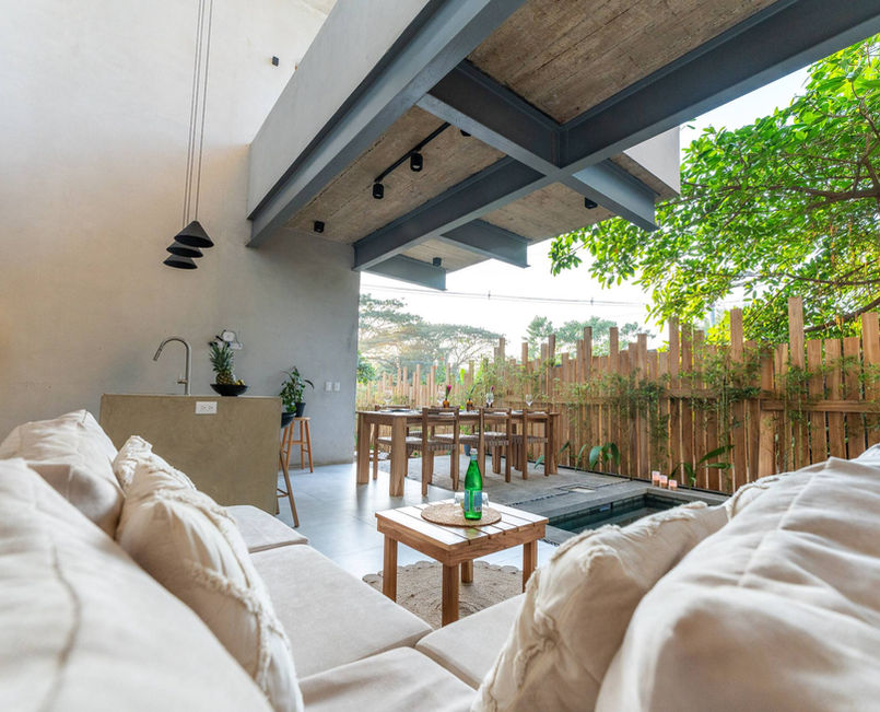 Open-air lounge with sofas overlooking the garden at Alma Tropical, a villa for a retreat in Costa Rica
